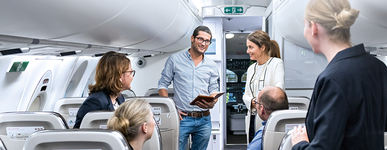 A group with training participants in an aircraft cabin