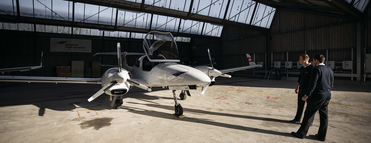 Two flight students: inside look at a training aircraft in a hangar at a location of the European Flight Academy.