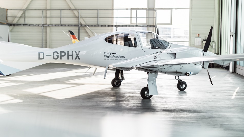 A training aircraft from the European Flight Academy is in a hangar
