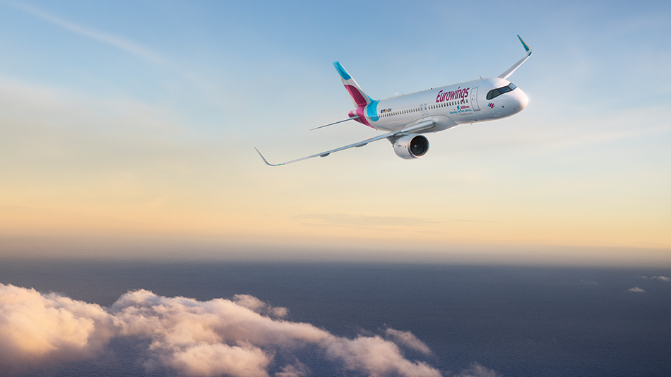 A first officer stands with a student pilot in front of an A350 and explains details.